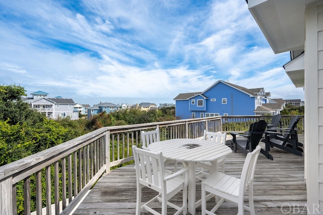 deck featuring a residential view and outdoor dining area