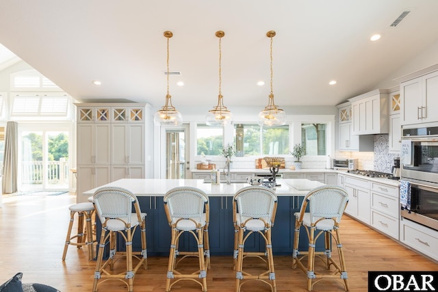 123 Skimmer Way Lot 48, Duck, NC 27949 - kitchen featuring healthy amount of natural light, stainless steel appliances, decorative backsplash, lofted ceiling, and light countertops