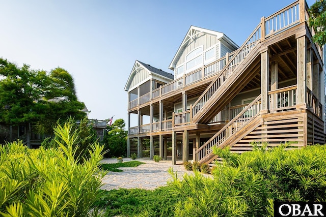 123 Skimmer Way Lot 48, Duck, NC 27949 - back of property with stairway, board and batten siding, a wooden deck, and a patio area