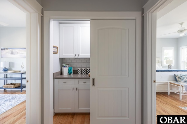 123 Skimmer Way Lot 48, Duck, NC 27949 - bar with light wood-style flooring and tasteful backsplash