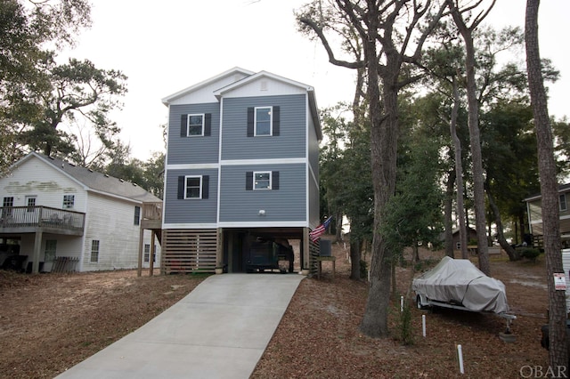 raised beach house with a carport and concrete driveway