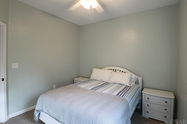 bedroom with a ceiling fan, dark carpet, and baseboards