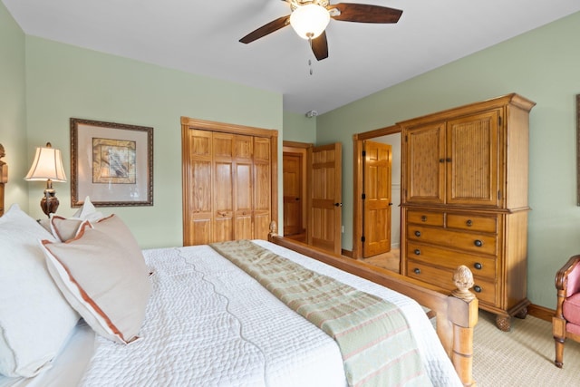 bedroom with ceiling fan, a closet, baseboards, and light colored carpet