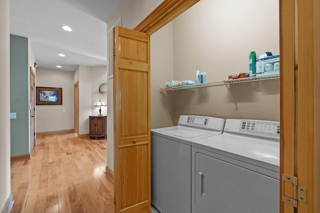 washroom featuring recessed lighting, laundry area, baseboards, washer and dryer, and light wood finished floors