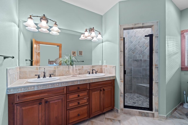 full bath featuring double vanity, tile patterned floors, a sink, and a shower stall