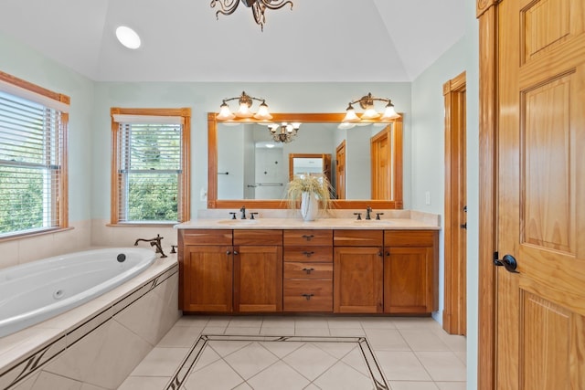 bathroom featuring tile patterned flooring, a notable chandelier, vaulted ceiling, and double vanity