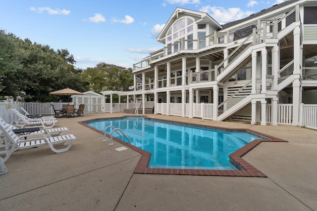 view of swimming pool with a patio, fence, and a fenced in pool