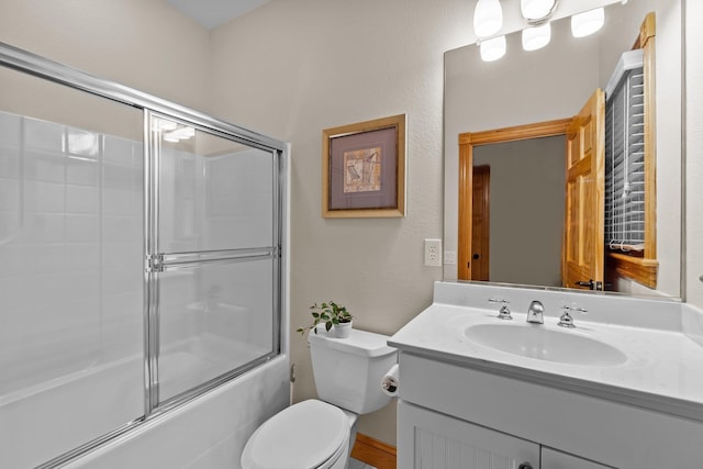 full bath with toilet, combined bath / shower with glass door, and vanity