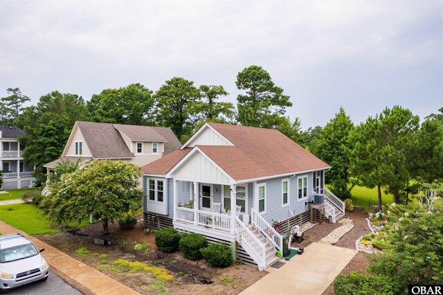 715 Arvilla Ln Lot 4, Manteo, NC 27954 - view of front of property featuring board and batten siding, covered porch, roof with shingles, and stairs