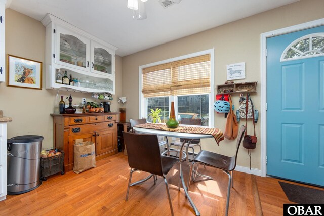 dining area featuring baseboards and light wood-style flooring