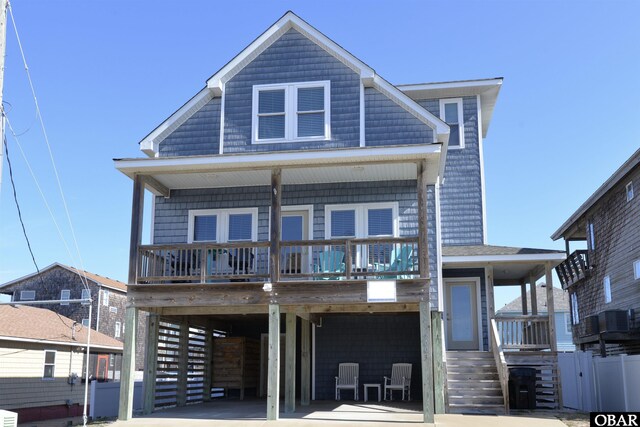 view of front facade with a carport, central air condition unit, and driveway