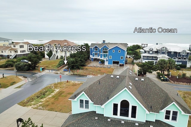 drone / aerial view with a residential view and a water view