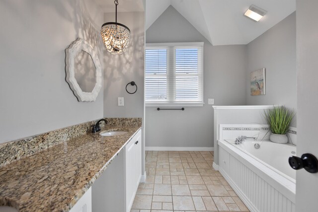 full bath with lofted ceiling, an inviting chandelier, baseboards, a bath, and vanity