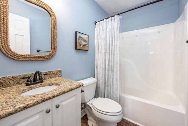 bathroom featuring shower / bath combo with shower curtain, toilet, wood finished floors, and vanity