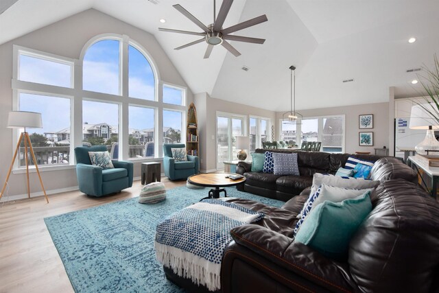 living room with recessed lighting, high vaulted ceiling, ceiling fan, and wood finished floors