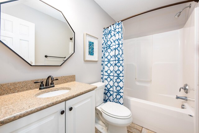 bathroom with vanity, shower / bath combination with curtain, and toilet