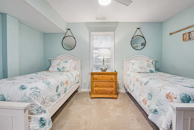 carpeted bedroom with visible vents, baseboards, and a ceiling fan