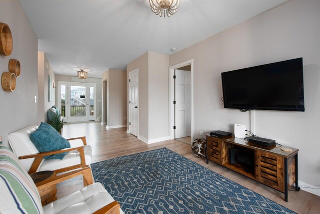 living area featuring baseboards and wood finished floors