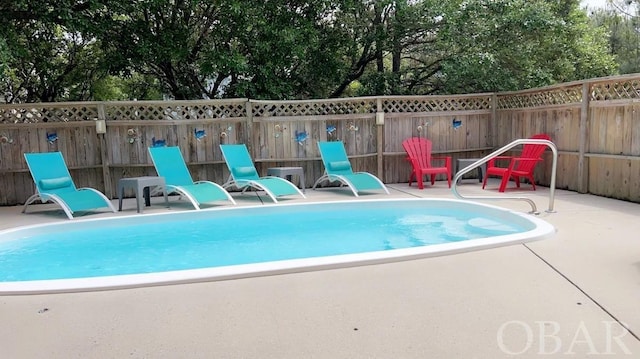 view of pool with a fenced in pool, fence private yard, and a patio