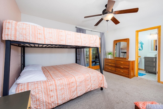 carpeted bedroom with a ceiling fan and connected bathroom