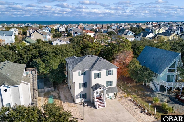 birds eye view of property with a residential view and a water view