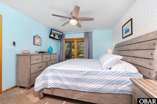 carpeted bedroom featuring access to outside, baseboards, ceiling fan, and a textured ceiling