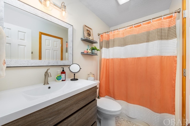 bathroom with a textured ceiling, toilet, and vanity