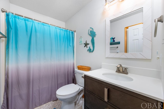 bathroom featuring a textured ceiling, toilet, and vanity