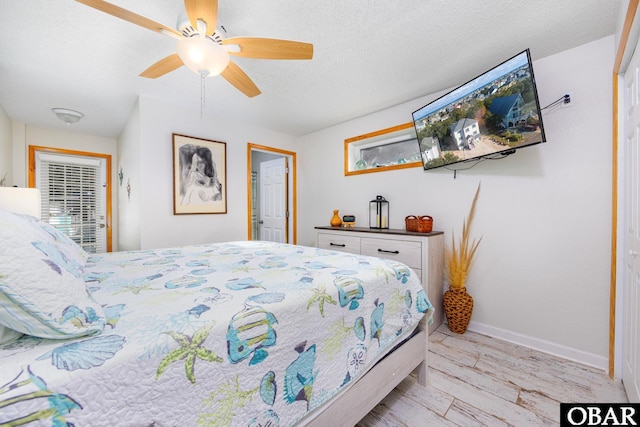 bedroom with a textured ceiling, ceiling fan, light wood-style flooring, and baseboards