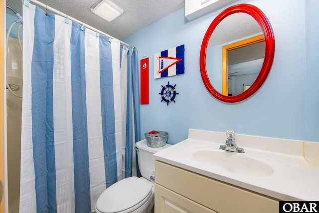 full bath featuring toilet, curtained shower, a textured ceiling, and vanity