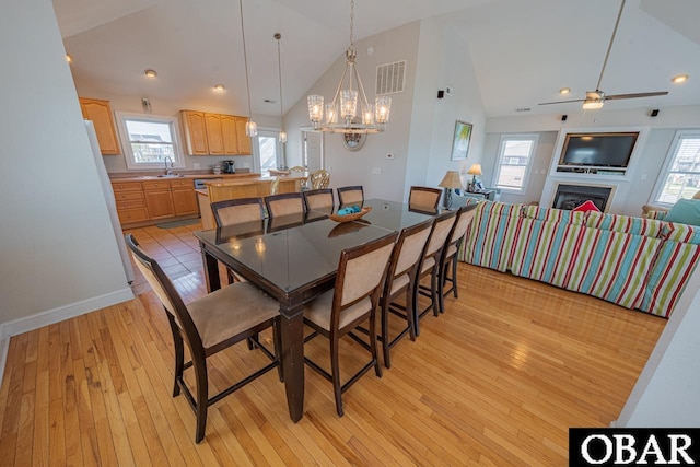 108 E Fresh Pond Dr Lot 24, Kill Devil Hills, NC 27948 - dining room with light wood-style floors, a chandelier, healthy amount of natural light, ceiling fan, and high vaulted ceiling
