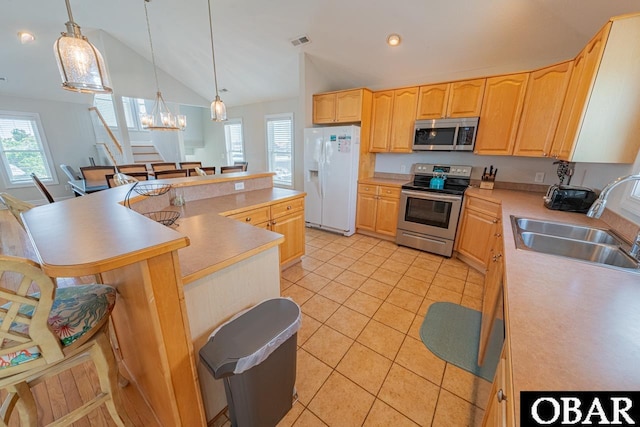 108 E Fresh Pond Dr Lot 24, Kill Devil Hills, NC 27948 - kitchen featuring stainless steel appliances, light tile patterned floors, plenty of natural light, light brown cabinets, and vaulted ceiling