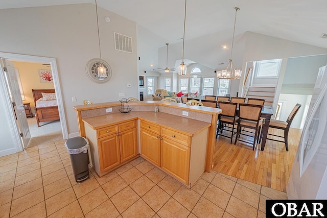 108 E Fresh Pond Dr Lot 24, Kill Devil Hills, NC 27948 - kitchen featuring light tile patterned floors, a chandelier, high vaulted ceiling, light countertops, and open floor plan