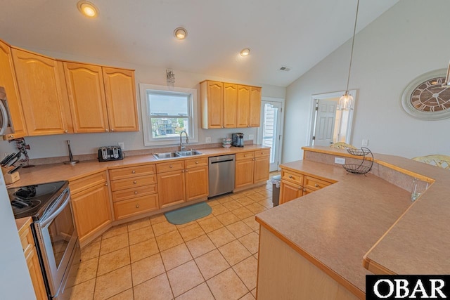 108 E Fresh Pond Dr Lot 24, Kill Devil Hills, NC 27948 - kitchen with stainless steel appliances, light brown cabinetry, vaulted ceiling, light countertops, and light tile patterned floors