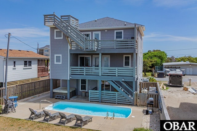 108 E Fresh Pond Dr Lot 24, Kill Devil Hills, NC 27948 - back of property with a balcony, stairway, a patio, a shingled roof, and a hot tub