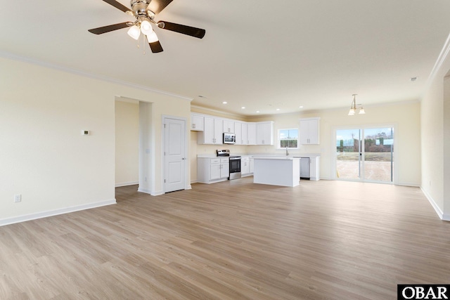 unfurnished living room with light wood finished floors, recessed lighting, baseboards, and ornamental molding