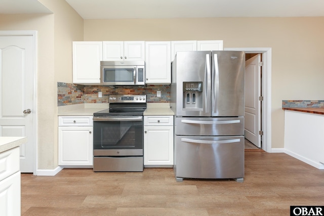 kitchen featuring stainless steel appliances, decorative backsplash, light countertops, and white cabinets