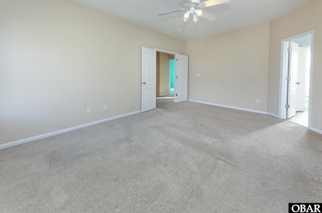 empty room featuring light carpet, ceiling fan, and baseboards