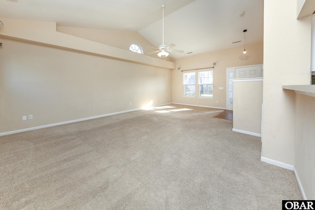 unfurnished room featuring lofted ceiling, ceiling fan, light carpet, and baseboards