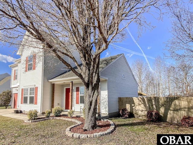 traditional home with fence and a front yard