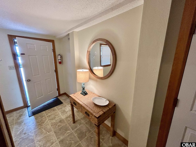2429 S Virginia Dare Trl Unit 4, Nags Head, NC 27959 - foyer entrance with a textured ceiling and baseboards