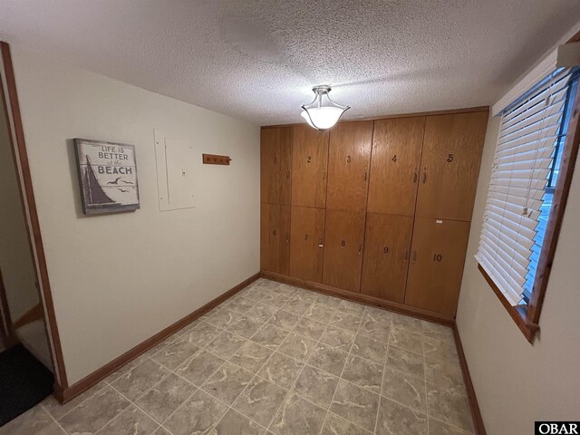 2429 S Virginia Dare Trl Unit 4, Nags Head, NC 27959 - unfurnished dining area with electric panel and a textured ceiling