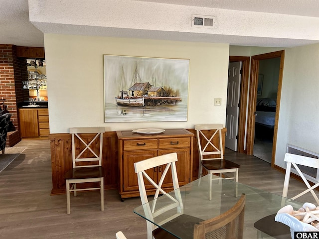 2429 S Virginia Dare Trl Unit 4, Nags Head, NC 27959 - dining space featuring a textured ceiling and wood finished floors