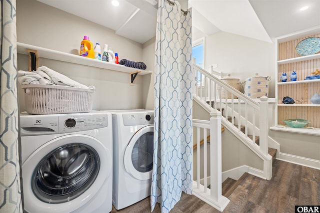 laundry area with baseboards, laundry area, dark wood finished floors, and washer and dryer