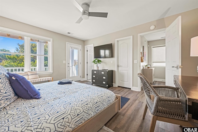 bedroom featuring dark wood-type flooring, a ceiling fan, visible vents, and baseboards