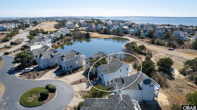 bird's eye view with a water view and a residential view