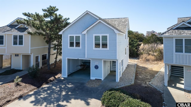 coastal home featuring concrete driveway