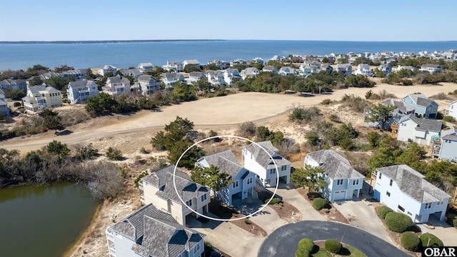 birds eye view of property with a water view and a residential view