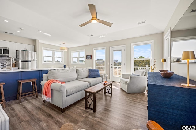 living area featuring ceiling fan, dark wood finished floors, visible vents, and recessed lighting