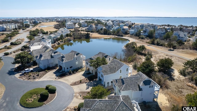 drone / aerial view featuring a residential view and a water view